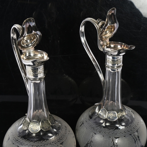 1116 - * Description amended*A pair of Edwardian cut-glass and silver plate-mounted decanters, with swan-ne... 