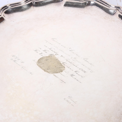 1123 - ASPREY - a silver plated salver of shaped form on 3 cast feet, bearing an inscription inviting the r... 