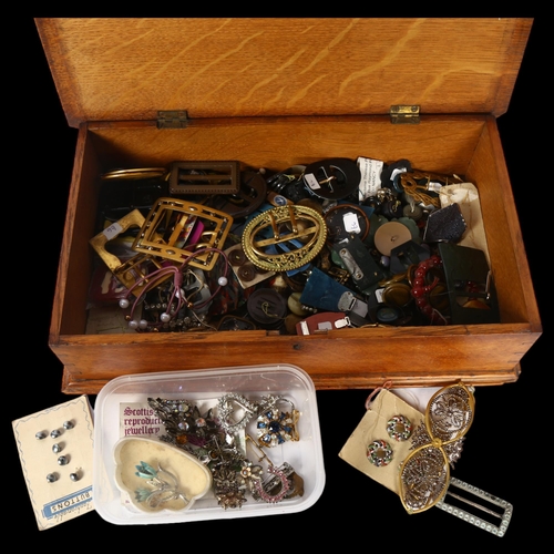 1132 - A box of miscellaneous costume jewellery, and buckles