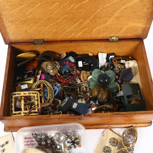 1132 - A box of miscellaneous costume jewellery, and buckles