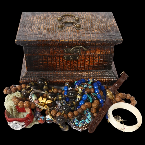 1140 - A quantity of costume jewellery, including carved nut necklace, bangle, Fossil wristwatch etc