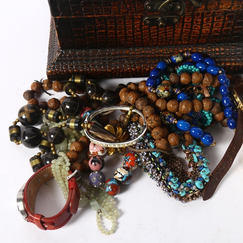 1140 - A quantity of costume jewellery, including carved nut necklace, bangle, Fossil wristwatch etc