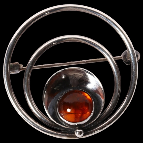 1171 - N E FROM, DANISH - a sterling silver and amber set circular design brooch