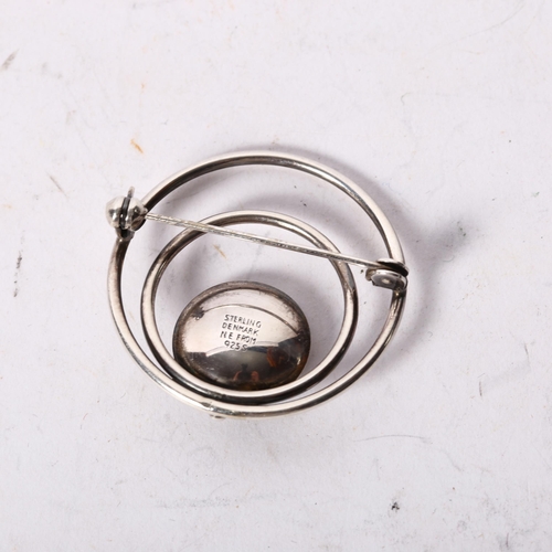 1171 - N E FROM, DANISH - a sterling silver and amber set circular design brooch