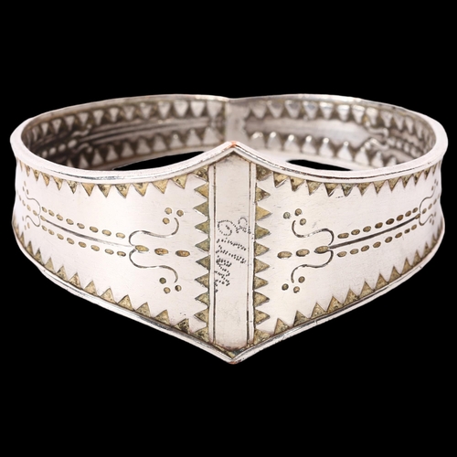 1172 - A Scandinavian Viking Revival bangle, with engraved decoration, unmarked silver settings,  named to ... 