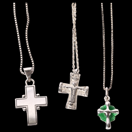 1174 - A group of 3 silver crucifixes and chains, 1 decorated with green enamel