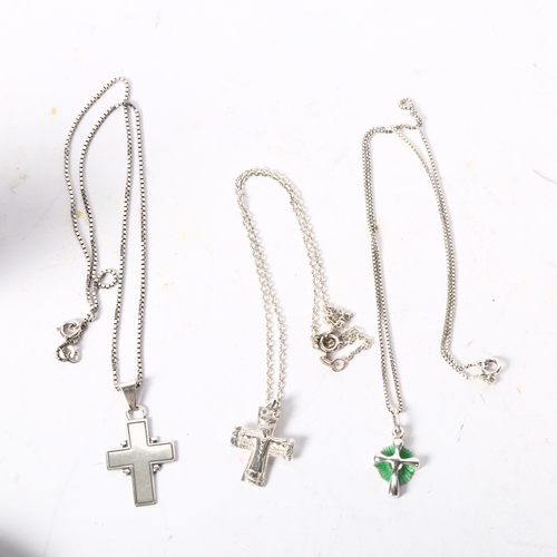 1174 - A group of 3 silver crucifixes and chains, 1 decorated with green enamel