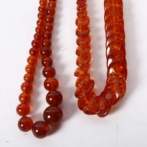 1176 - 2 phenolic amber necklaces, 1 oval disc design, length 59cm, and a bead design, length 71cm (the cat... 