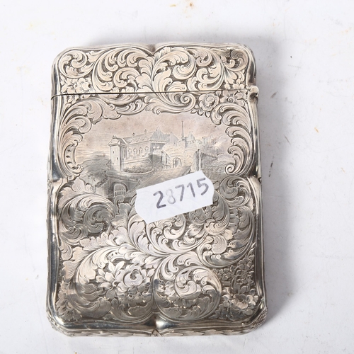 1186 - An ornate scrolled engraved silver plated card case, named to M Downie