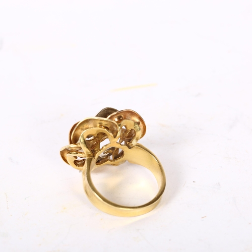 1194 - A stylised 18ct gold flowerhead design dress ring, size K, 8.1g