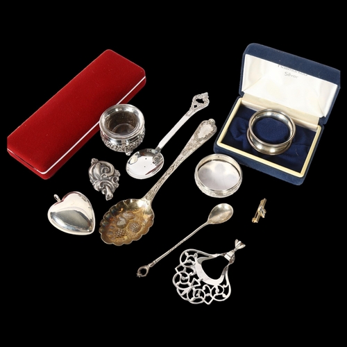 1202 - A tray of items to include a silver spoon and napkin ring, plated heart-shaped locket, plated salt e... 