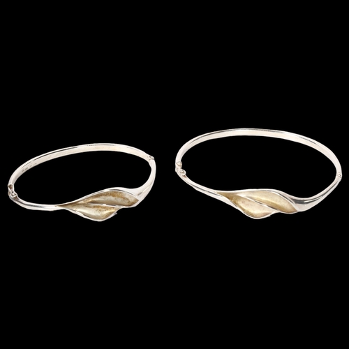 1204 - AAGAARD - a graduated pair of Danish sterling silver hinged bangles, modernist design