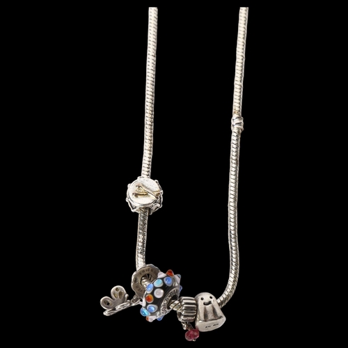 1209 - PANDORA - a sterling silver snake link charm bracelet, with 5 various charms, length 44cm, boxed