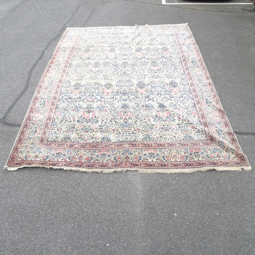 2342 - A large cream ground Persian style carpet. 439 x 315cm