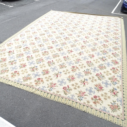 2344 - A large floral decorated cream ground wool carpet. 610 x 436cm.