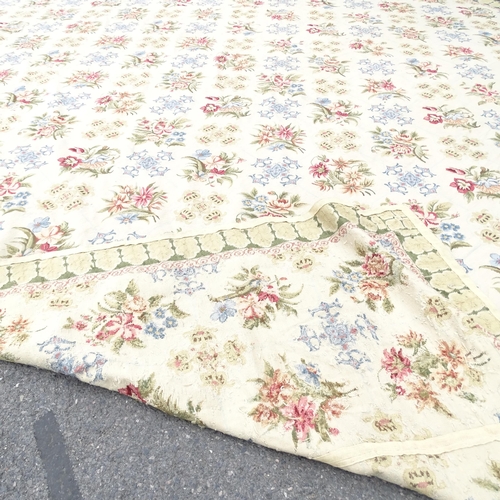 2344 - A large floral decorated cream ground wool carpet. 610 x 436cm.