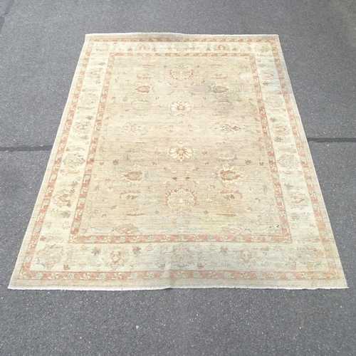 2346 - A large cream ground oriental style carpet. 310 x 240cm.