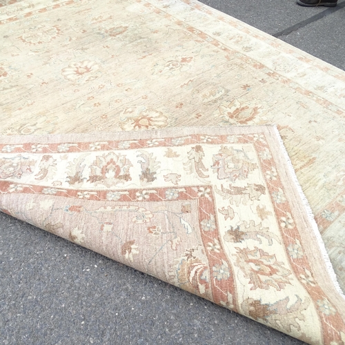 2346 - A large cream ground oriental style carpet. 310 x 240cm.