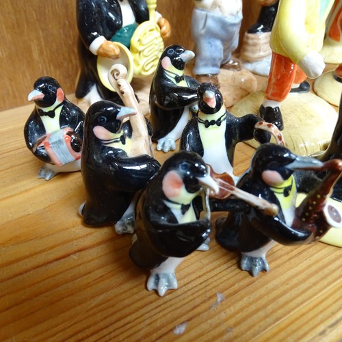 950 - A group of 8 Beswick cat musicians, and 6 miniature porcelain penguin musicians