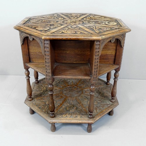 2193 - A Victorian Arts & Crafts octagonal two-tier library table, with relief carved foliate decoration. 7... 