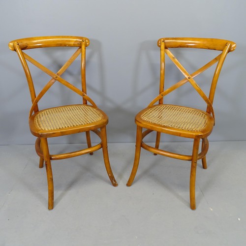 2746 - A pair of modern teak cane seated cross back dining chairs.