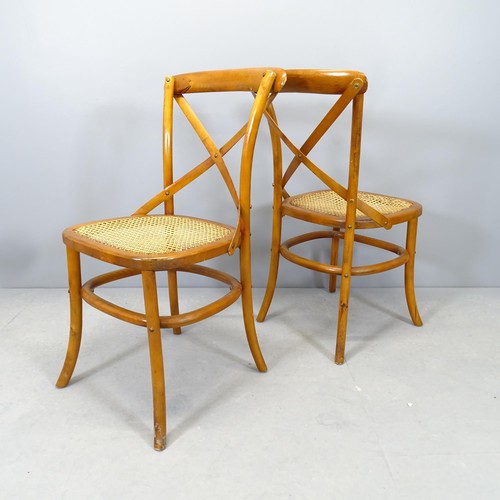 2746 - A pair of modern teak cane seated cross back dining chairs.