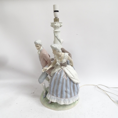 642 - A large Lladro porcelain table lamp supported by 3 figures in Period costume, on plinth (A/F), heigh... 