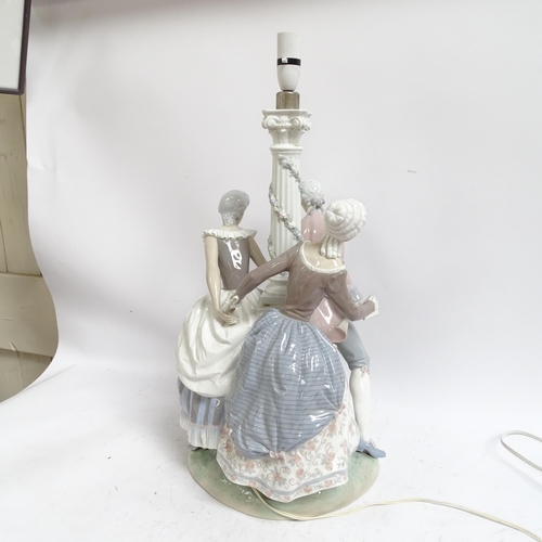 642 - A large Lladro porcelain table lamp supported by 3 figures in Period costume, on plinth (A/F), heigh... 