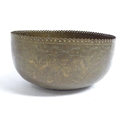 598 - A Tibetan engraved brass singing bowl with design of figures and foliage, and shaped pierced rim, 30... 