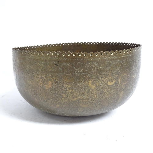 598 - A Tibetan engraved brass singing bowl with design of figures and foliage, and shaped pierced rim, 30... 