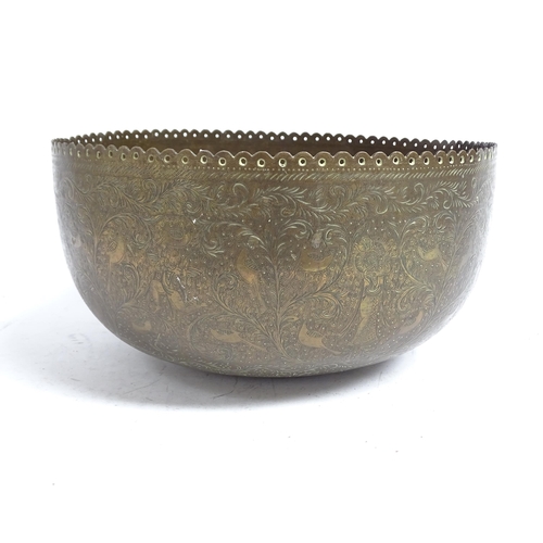 598 - A Tibetan engraved brass singing bowl with design of figures and foliage, and shaped pierced rim, 30... 