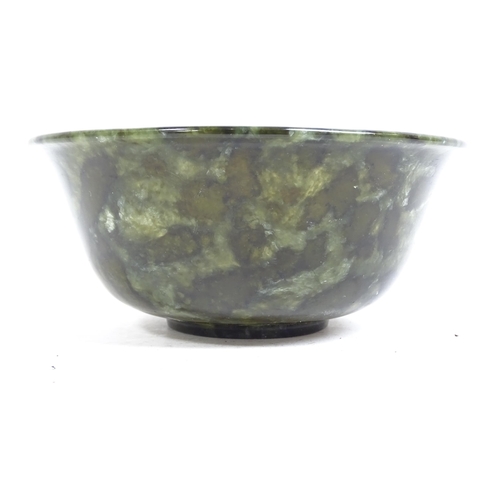 1022 - A jade bowl and a spinach jade bowl, on foot, 12.5cm across