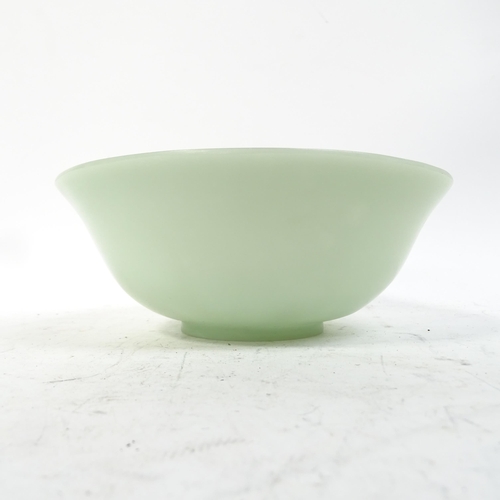 1022 - A jade bowl and a spinach jade bowl, on foot, 12.5cm across