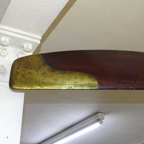 2205 - A large vintage aircraft propeller in mahogany with brass mounts, with inset clock. Length 250cm.