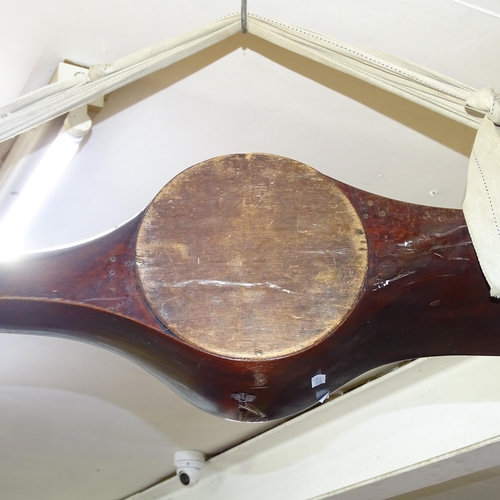 2205 - A large vintage aircraft propeller in mahogany with brass mounts, with inset clock. Length 250cm.