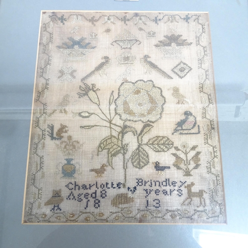 609 - A Regency Period cross-stitch sampler by Charlotte Brindley aged 8 years, 1813, with design of flowe... 