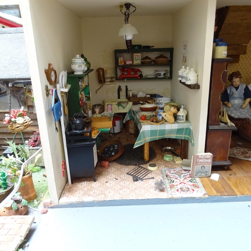 224 - A 1940s style doll's house and garden, 2 floors with fitted interior and associated garden scene, in... 