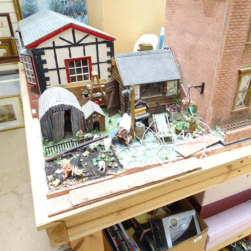 224 - A 1940s style doll's house and garden, 2 floors with fitted interior and associated garden scene, in... 