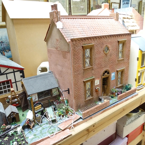 224 - A 1940s style doll's house and garden, 2 floors with fitted interior and associated garden scene, in... 