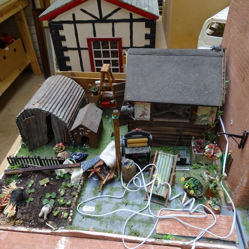 224 - A 1940s style doll's house and garden, 2 floors with fitted interior and associated garden scene, in... 