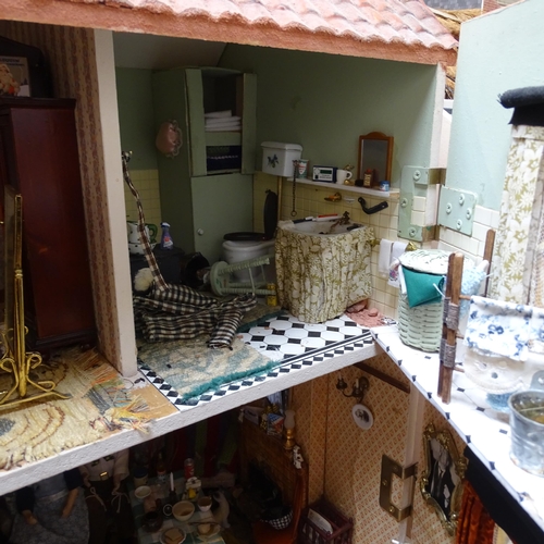 224 - A 1940s style doll's house and garden, 2 floors with fitted interior and associated garden scene, in... 