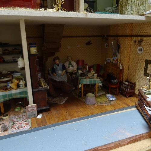 224 - A 1940s style doll's house and garden, 2 floors with fitted interior and associated garden scene, in... 