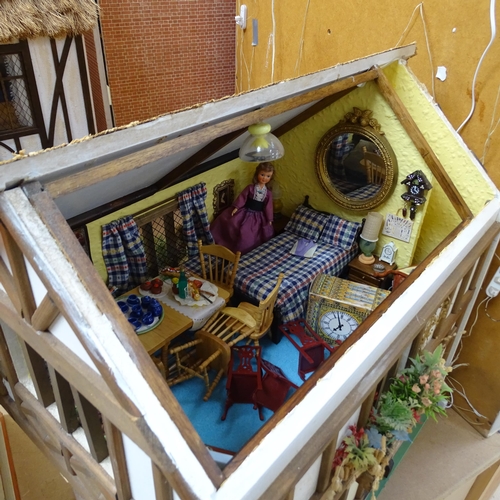 227 - A Tudor style doll's house, over 2 floors, with partially removeable roof, fitted interior, includes... 