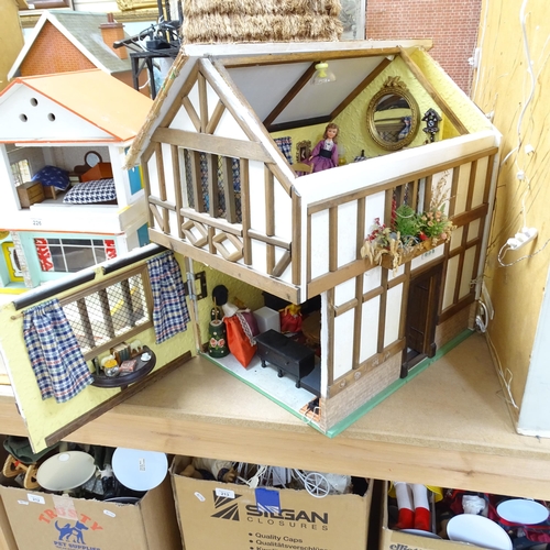 227 - A Tudor style doll's house, over 2 floors, with partially removeable roof, fitted interior, includes... 