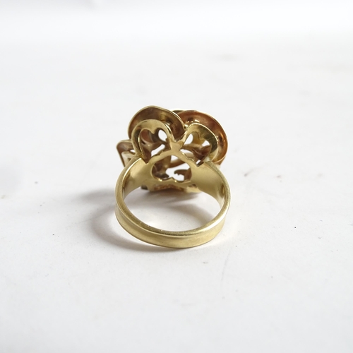 1194 - A stylised 18ct gold flowerhead design dress ring, size K, 8.1g