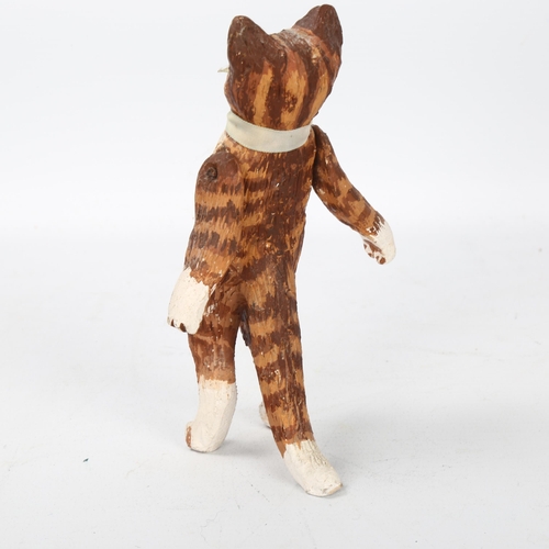 504 - A late 20th century ceramic standing cat, with articulated front legs, unsigned, height 14cm