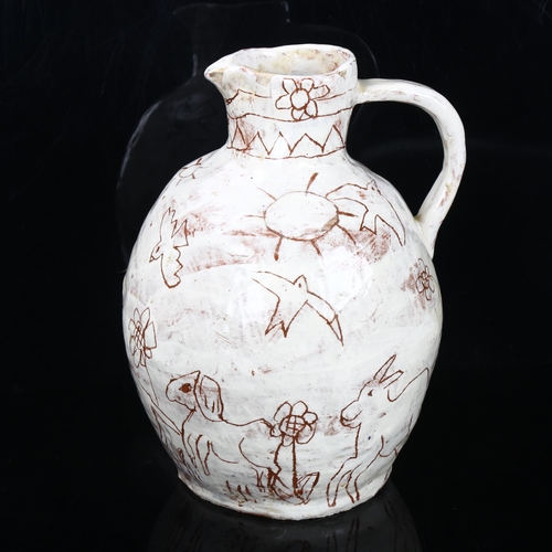 509 - A handbuilt earthenware art jug with sgraffito decoration, artist initals L.C. to base, height 25cm