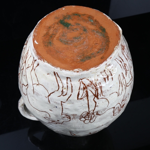 509 - A handbuilt earthenware art jug with sgraffito decoration, artist initals L.C. to base, height 25cm