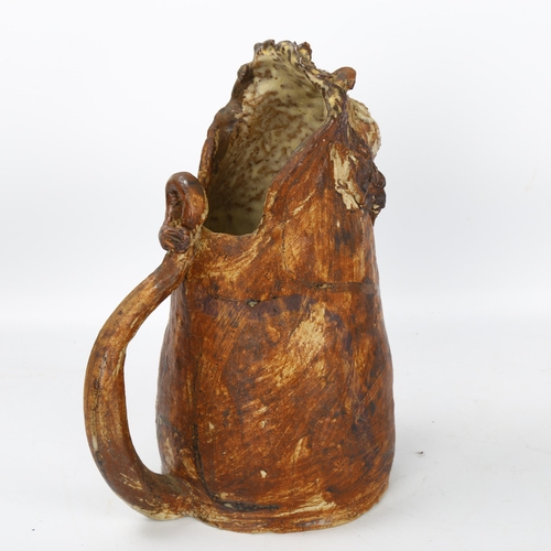 510 - A handbuilt stoneware art jug in Lion form, artist initial L.C. to base, height 26cm