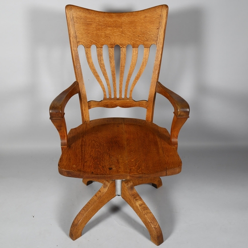 520 - An early 20th century, Art Nouveau oak desk chair, with tilt and swivel patented mechanism, height 1... 